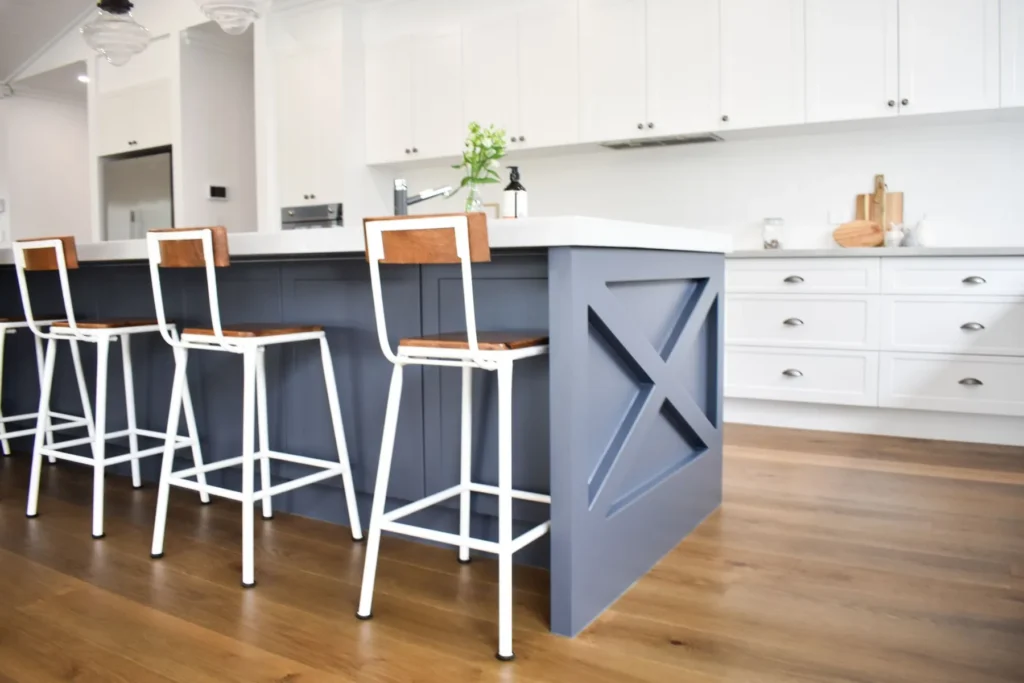 Kitchen island bench with a seating overhang and bar stools